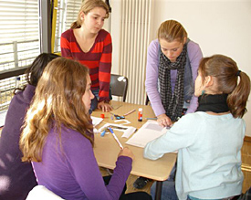 Sch&uuml;lerinnen aus der Klasse 8a diskutieren intensiv &uuml;ber die Gestaltung ihres Kalenderblatts 